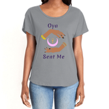 Feel the magic of wearing this comfortable grey colored women's T-Shirt with the name of the West African goddess Oya, and the message - "Oya Sent Me" in dark purple letters. It has brilliant graphics of hands circling a new moon with an ankh. Fabric laundered for relaxed fit